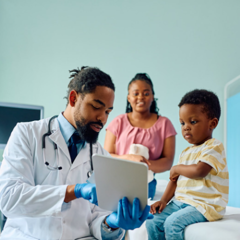 pediatrician with patient and caregiver